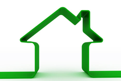 Green ribbon forming the shape of a house, symbolizing energy efficiency and eco-friendly home solutions